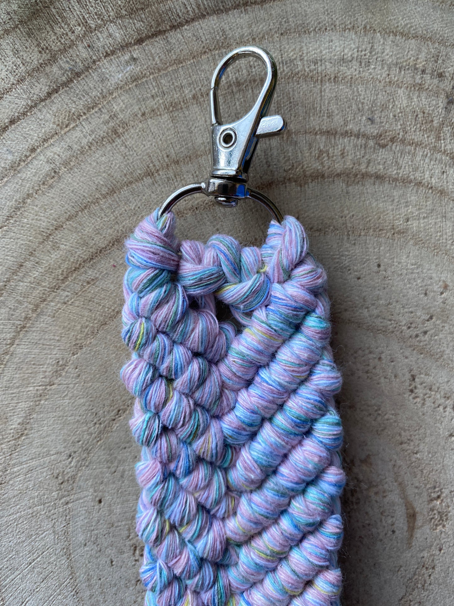 A handmade macrame keyring, knotted using soft pastel coloured recycled cotton and finished with a metal lobster clasp. 