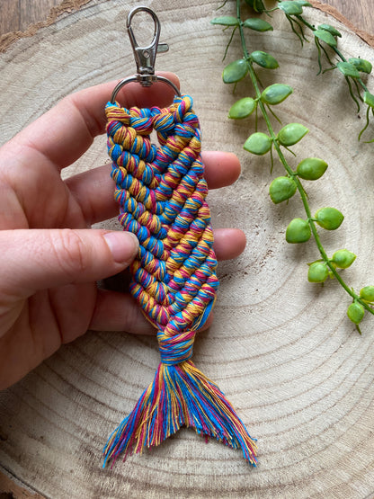 A handmade macrame keyring, knotted using brightly coloured recycled cotton in the shape of a mermaids tail, and finished with a metal lobster clasp. 